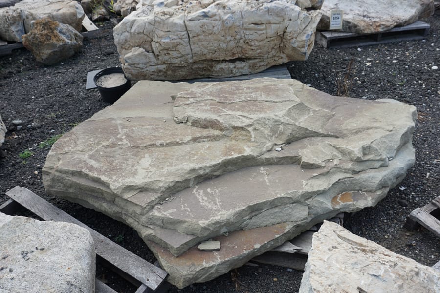 Close-up photo of an individual placement rock. It shows how textured, irregular and unique a placement rock can be. This particular stone could also be used as a spill rock to allow water to cascade down in a water garden or waterfall.