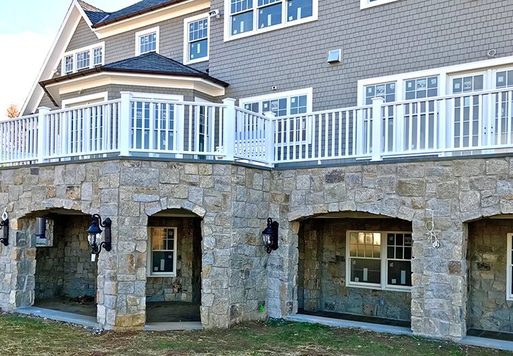 A picture of a finished veneer stone job using Rstone's Beachwood squares and recs on a house
