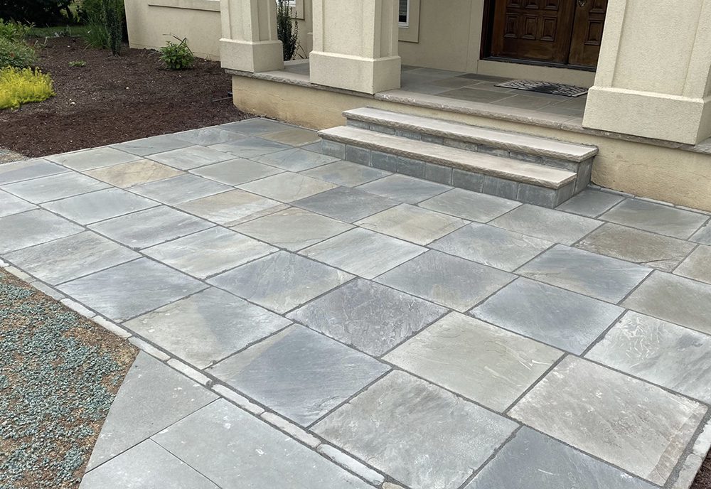 A picture of a bluestone landing area outside a front entrance