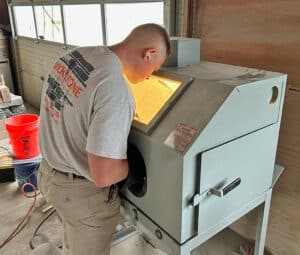 Stone Engraving Process - a the design is carefully cut out of stone using the sand blasting machine in our fabrication facility