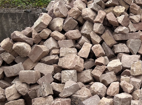 A photo of snapped brownstone bulk wall stone