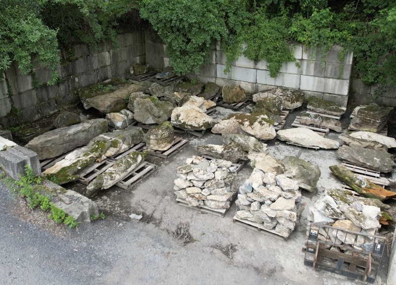 Our moss rock comes on pallets too. This picture shows our palleted moss rock boulders. Our moss rock holding area. Everything is on pallets in this shaded area of our stone yard