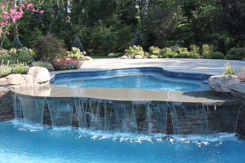 A bluestone spill rocks allows water to spill over from the spa into the main pool