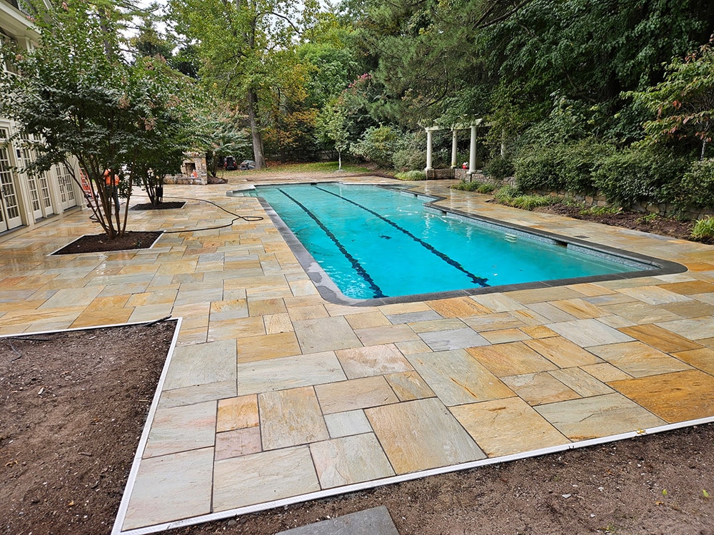 A pool deck freshly laid using our desert quartzite pattern stone