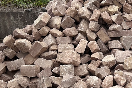 A picture of a bin of reclaimed brownstone building and landscape stone