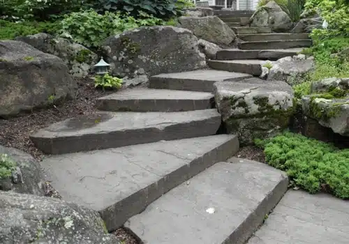 a picture of a series of natural stone steps coming down a slope